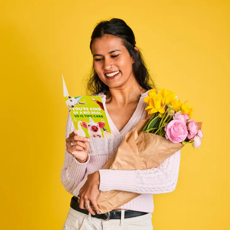 Australia: Safia holds up an Oxfam Unwrapped card and a bouquet of flowers. Photo: Michelle Jarni Australia: Safia holds up an Oxfam Unwrapped card and a bouquet of flowers. Photo: Michelle Jarni