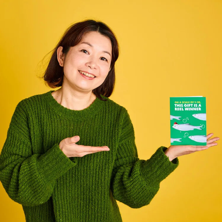 Australia: Mariko holds up an Oxfam Unwrapped card. Photo: Michelle Jarni